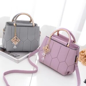 Chic Pink Quilted Handbag with Gold Tone Handles and Decorative Crystal Pendant - Perfect for Everyday Use